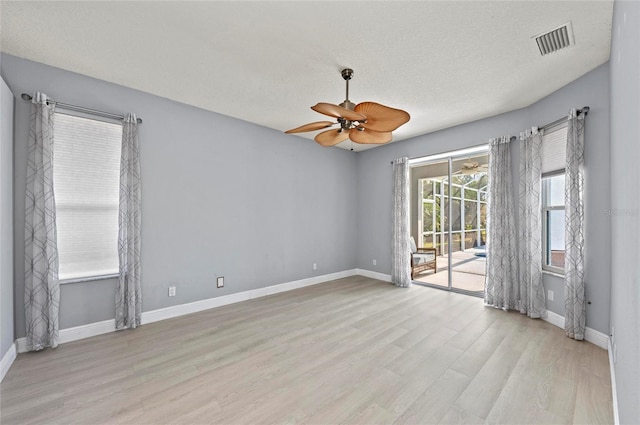 unfurnished room featuring ceiling fan, a textured ceiling, and light hardwood / wood-style floors