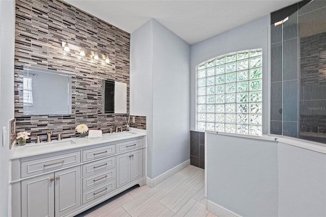 bathroom featuring vanity and backsplash