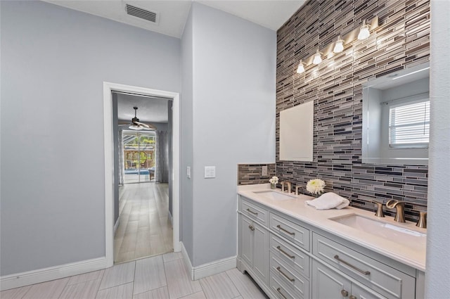 bathroom featuring tasteful backsplash, ceiling fan, vanity, and a wealth of natural light