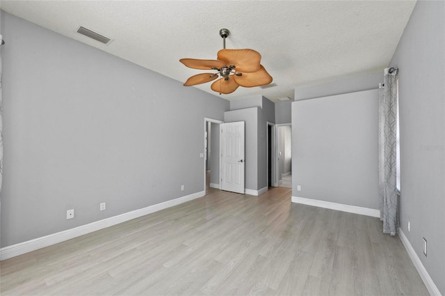 unfurnished bedroom with ceiling fan, a textured ceiling, and light wood-type flooring