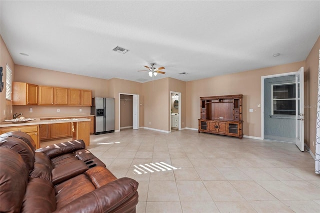 living room with ceiling fan and light tile patterned floors