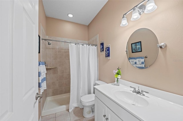 bathroom with a shower with curtain, vanity, tile patterned floors, and toilet