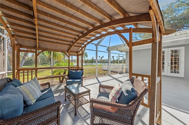 sunroom featuring vaulted ceiling and plenty of natural light