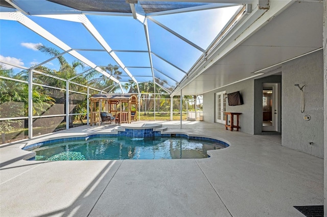 view of pool with glass enclosure, a patio area, a jacuzzi, french doors, and pool water feature