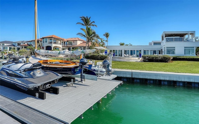 dock area featuring a water view and a yard