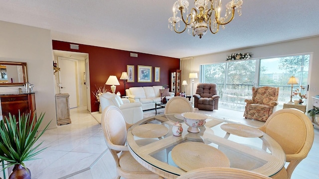 dining room with an inviting chandelier and a textured ceiling