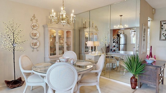 dining area featuring a chandelier and light hardwood / wood-style flooring