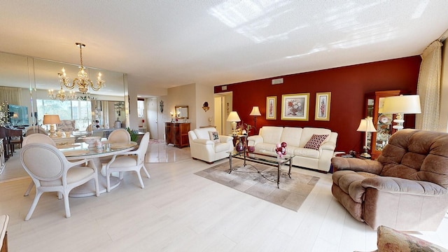 living room with a textured ceiling and an inviting chandelier