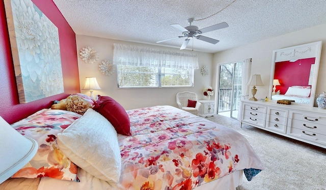 bedroom with ceiling fan, carpet floors, access to exterior, and a textured ceiling