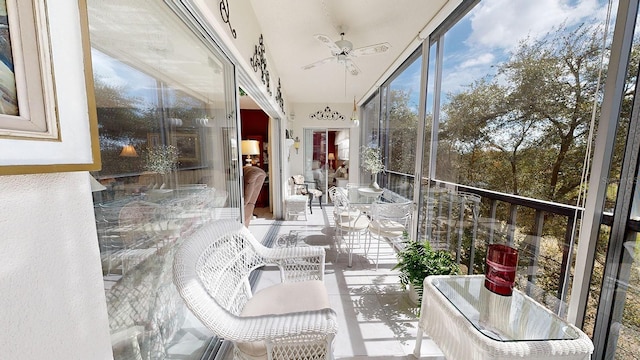 sunroom / solarium featuring ceiling fan