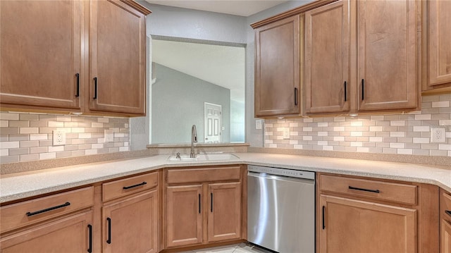 kitchen with a sink, tasteful backsplash, light countertops, and dishwasher