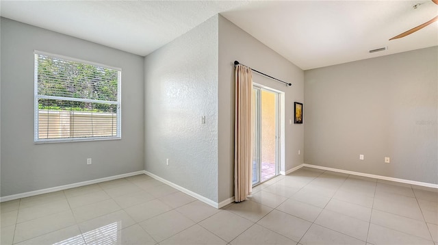 unfurnished room featuring light tile patterned floors, visible vents, and baseboards