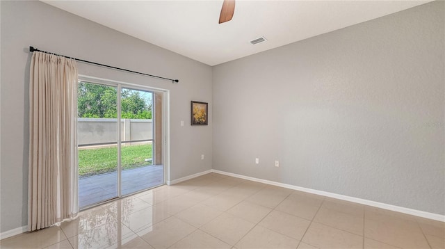 empty room featuring visible vents, baseboards, a ceiling fan, and light tile patterned flooring