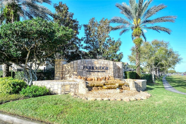 community / neighborhood sign with a lawn