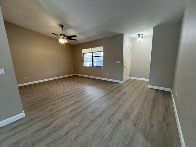 interior space featuring ceiling fan, light hardwood / wood-style flooring, and a textured ceiling