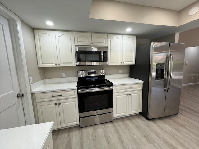 kitchen with white cabinetry, light hardwood / wood-style floors, and appliances with stainless steel finishes