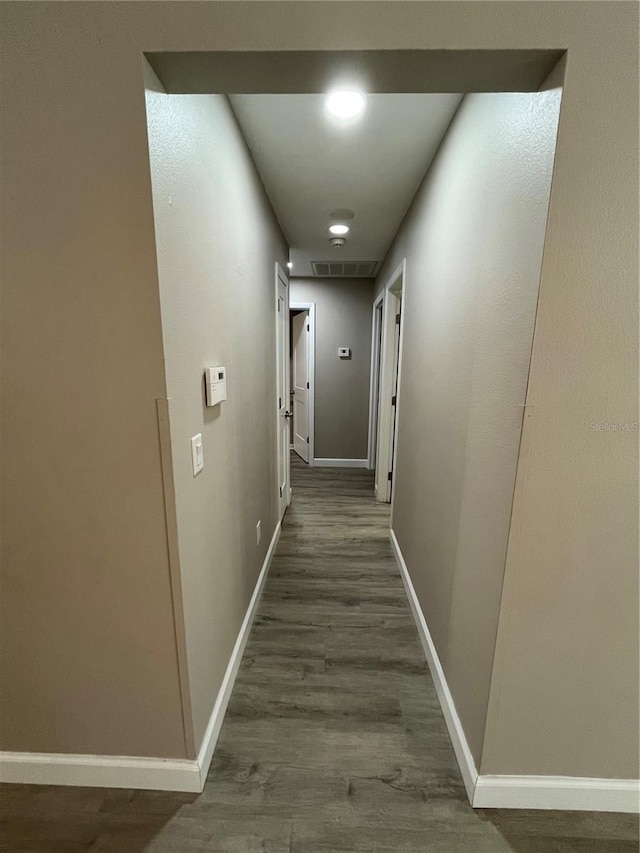 hallway with dark wood-type flooring