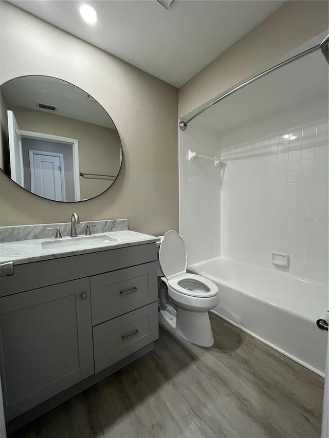 full bathroom featuring vanity, wood-type flooring, toilet, and shower / bath combination