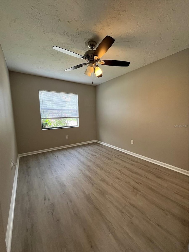 spare room featuring hardwood / wood-style floors, a textured ceiling, and ceiling fan