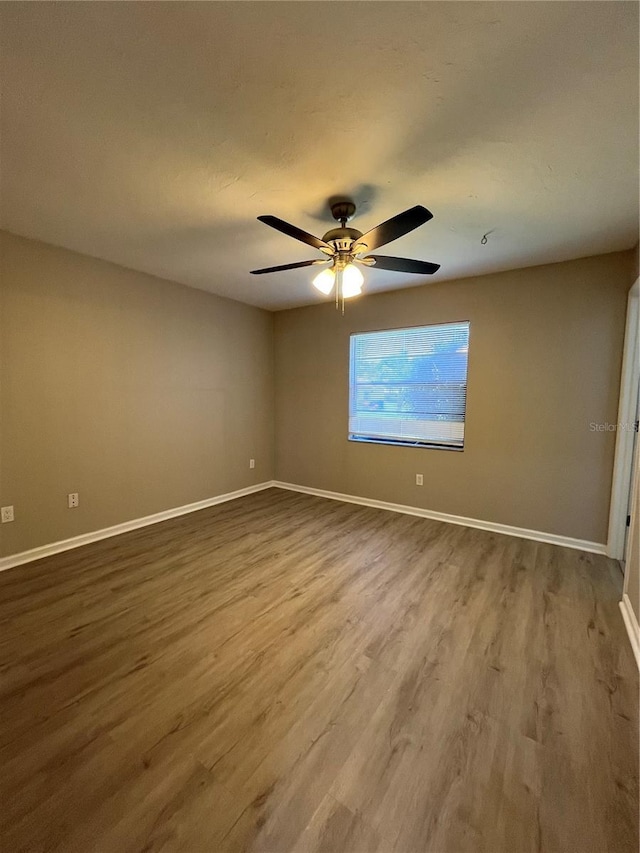 empty room featuring ceiling fan and hardwood / wood-style floors