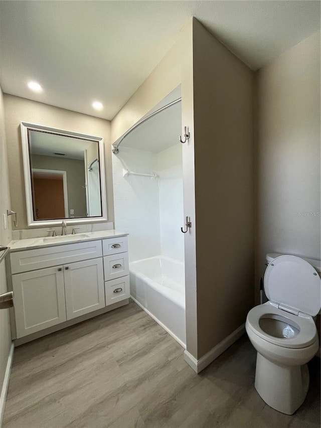 full bathroom featuring shower / bathtub combination, vanity, toilet, and hardwood / wood-style floors