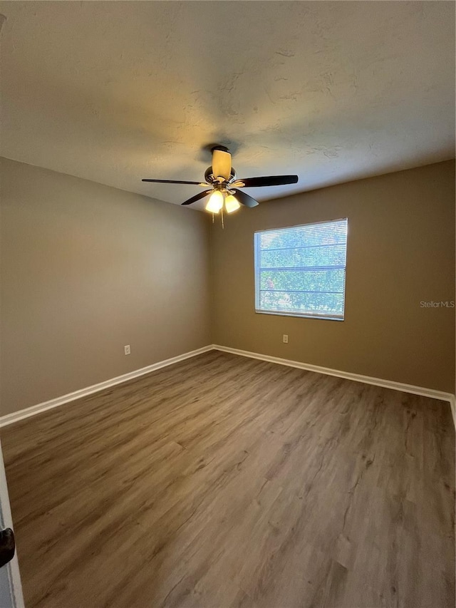 spare room with ceiling fan, hardwood / wood-style floors, and a textured ceiling