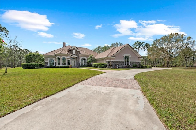 ranch-style home featuring a front yard