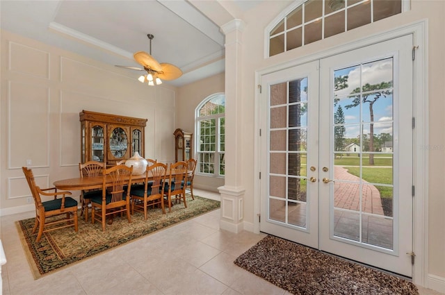 dining space with ceiling fan, french doors, light tile patterned floors, and ornamental molding