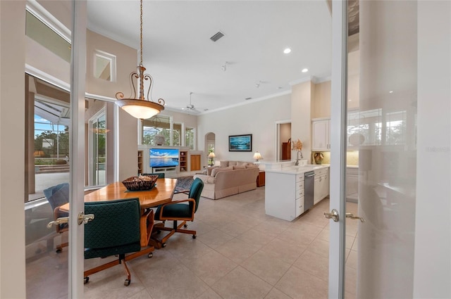 dining area featuring sink, ornamental molding, light tile patterned flooring, and ceiling fan