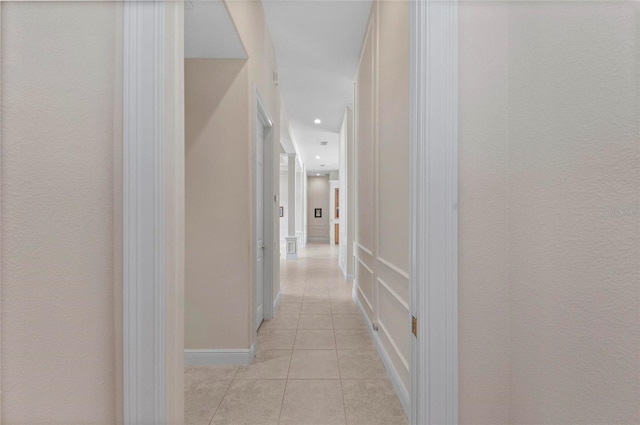 corridor with light tile patterned floors