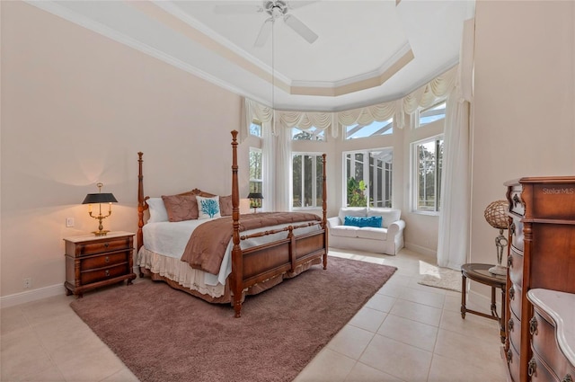 tiled bedroom featuring ceiling fan, ornamental molding, and a raised ceiling