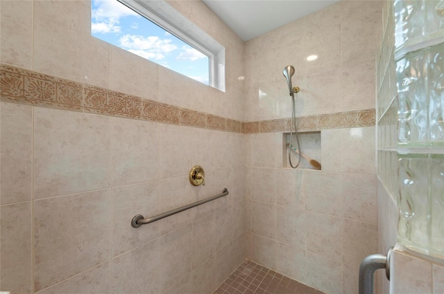 bathroom with tiled shower