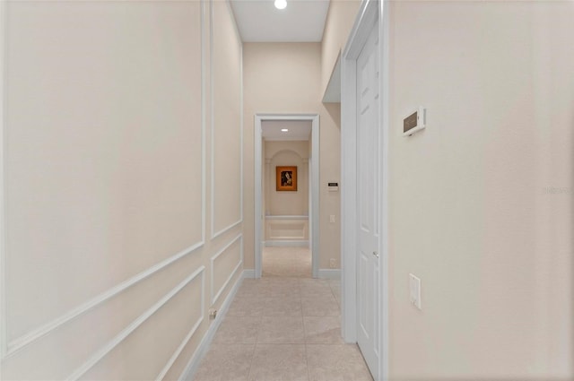 hall with light tile patterned floors