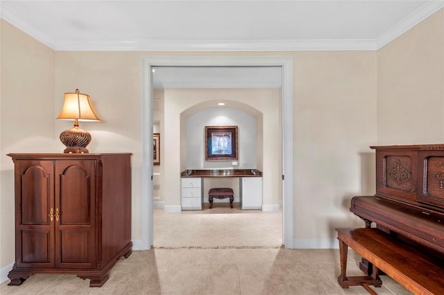 hallway featuring crown molding and light tile patterned flooring