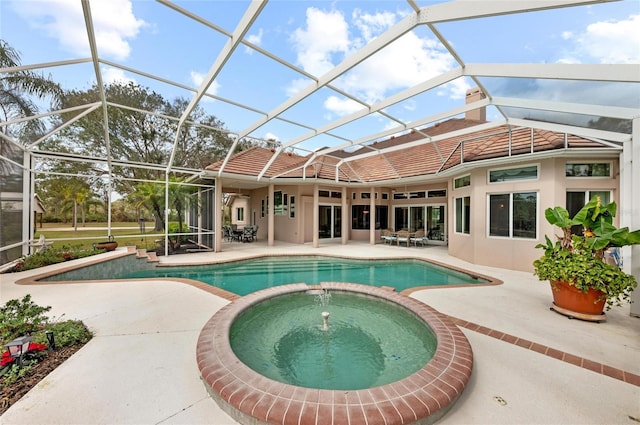 view of pool featuring an in ground hot tub, a patio, and glass enclosure