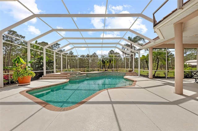 view of pool featuring an in ground hot tub, a patio, and glass enclosure