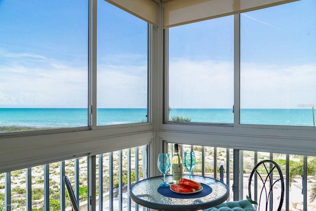 unfurnished sunroom with a water view