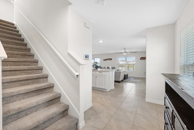 stairs with tile patterned flooring and ceiling fan