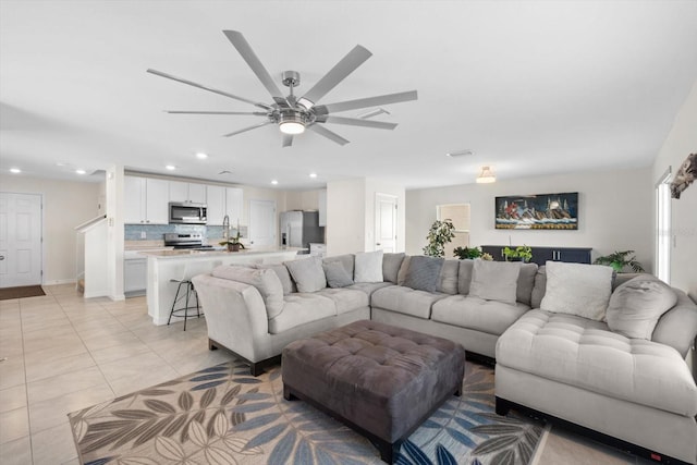 living room with ceiling fan and light tile patterned flooring