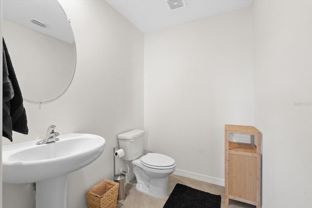 bathroom featuring tile patterned floors and toilet