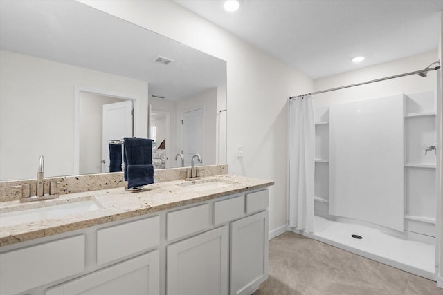 bathroom featuring vanity and a shower with shower curtain