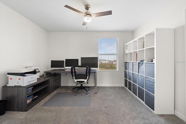 carpeted office space with ceiling fan