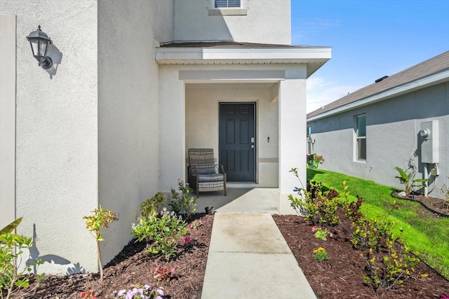 property entrance featuring stucco siding