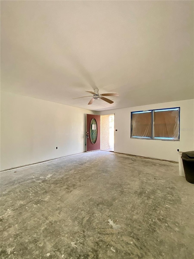 interior space with ceiling fan