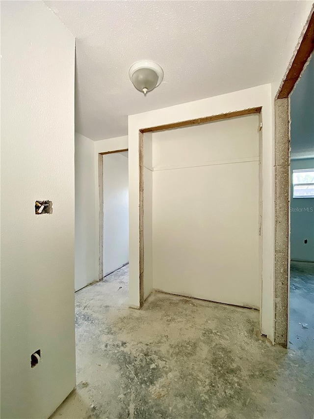 corridor featuring a textured ceiling