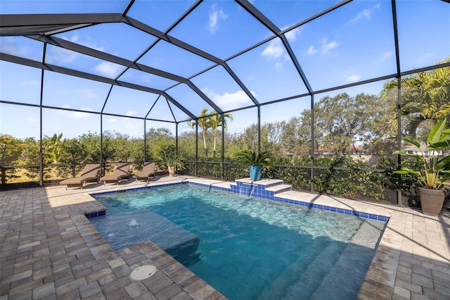 view of pool with a lanai, a patio, and pool water feature