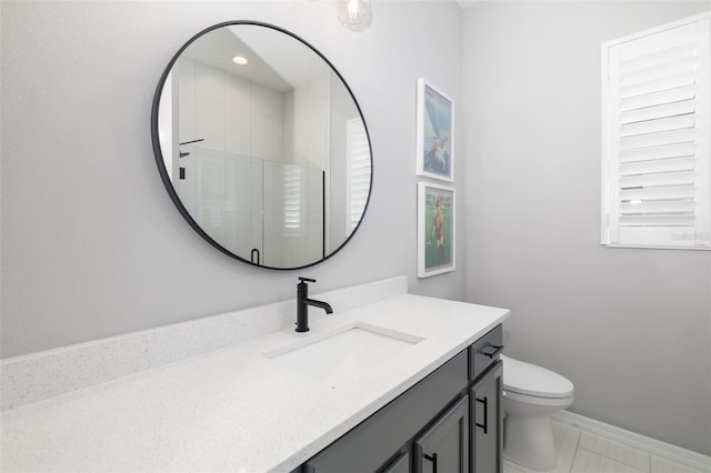 bathroom with vanity, toilet, and an enclosed shower