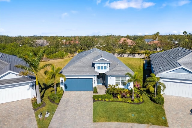 view of front of home with a garage and a front lawn