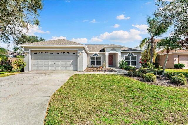 ranch-style home featuring a garage and a front yard