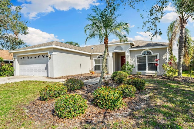 single story home featuring a garage and a front yard